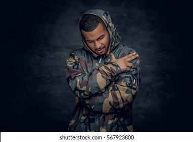 Studio portrait of Black man dressed in military jacket.