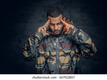 Studio portrait of Black man dressed in military jacket.
