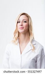 Studio Portrait Of A Blonde Woman In A White Coat That Could Be A Scientist Or A Lab Technician