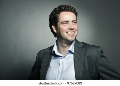 Studio Portrait Of Business Man Isolated On Grey Background