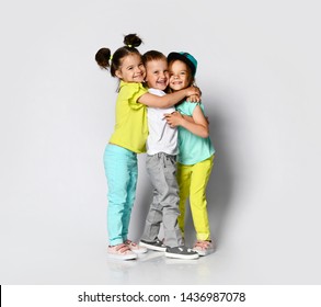 Studio portrait of children on a light background: full body shot of three children in bright clothes, two girls and one boy. Triplets  - Shutterstock ID 1436987078