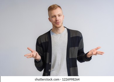 Studio Portrait Concept Of A Smiling Young Man Talking On A White Background.