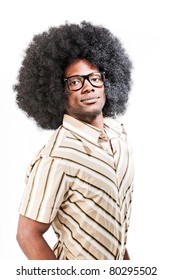 Studio Portrait Of Cool Black Young Man With Black Glasses, Striped Retro 70s Shirt And Retro Afro Hair Isolated On White Background.