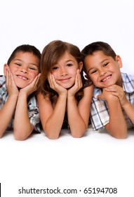 Studio Portrait Of Family Group Of Children With Sister Beside Two Brothers.