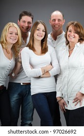 Studio Portrait Of Family With White Shirt Isolated On Grey Background