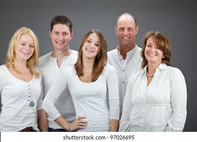 Studio Portrait Of Family With White Shirt Isolated On Grey Background