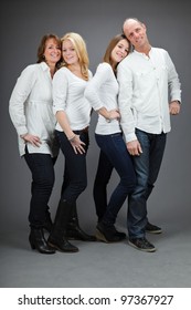 Studio Portrait Of Family With White Shirt Isolated On Grey Background