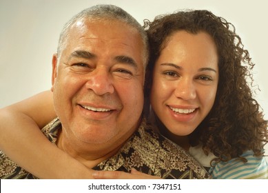Studio portrait of father and daughter laughing and being happy