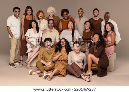 Studio portrait of a group of beautiful multiethnic people smiling on a neutral background.