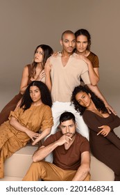 Studio portrait of a group of beautiful multiracial people posing together on a neutral background. Stock Photo