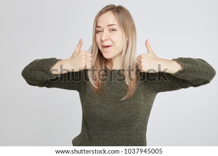 Studio portrait of happy cute young successful woman giving two thumbs up gesture in full disbelief isolated on white wall background. Positive human emotion, facial expression, body language concept