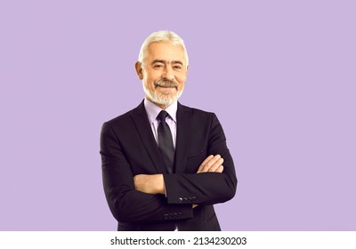 Studio portrait of happy experienced businessman, company founder and business professional. Cheerful white haired senior man in smart suit, shirt and elegant tie isolated on solid purple background - Shutterstock ID 2134230203