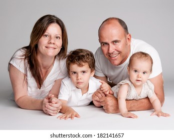 Studio Portrait Of Happy Family.