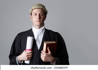 Studio Portrait Of Lawyer Holding Brief And Book