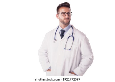 Studio Portrait Of Male Doctor Standing At Isolated White Background While Looking Away.