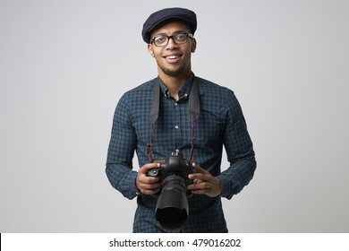 Studio Portrait Of Male Photographer With Camera