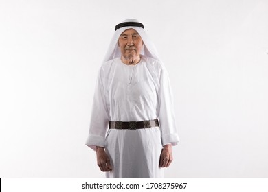 Studio Portrait Of An Old Arab Man In White Clothes On A White Background