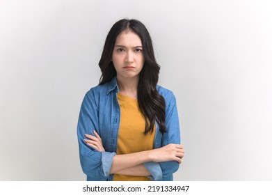 Studio portrait photo of young Asian woman with anger face expression on white background. Young woman emotion face expression portrait concept.