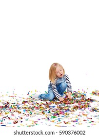 Studio Portrait Of Pretty Blond Girl Busy Playing With Colorful Confetti And Picking It Up From Floor, Opening Mouth In Concentration