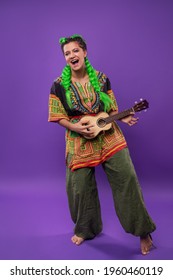 Studio Portrait Of Rasta Woman With Light Green Hair Playing Ukulele