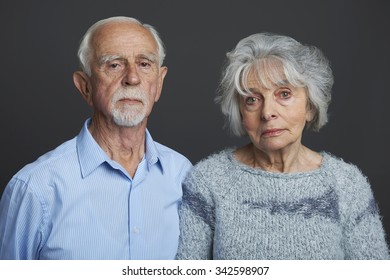 Studio Portrait Of Serious Senior Couple