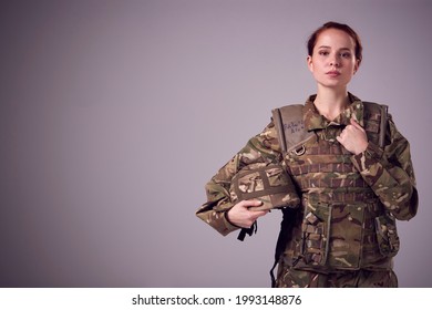 Studio Portrait Of Serious Young Female Soldier In Military Uniform Against Plain Background - Shutterstock ID 1993148876