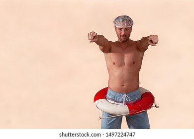 Studio Portrait Of A Shirtless Man, With A Life Ring And Shower Hood, Both Arms Stretched Out With Fingers.