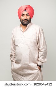 Studio portrait of a sikh handsome man looking at camera with smile