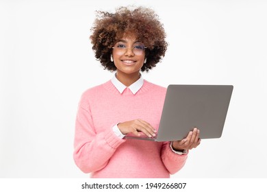 Studio portrait of smiling african american teen girl looking at camera, online course student holding laptop, isolated on gray background - Powered by Shutterstock