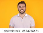 Studio portrait of Smiling male model isolated on yellow. Positive man in good mood. Friendly and smiling man. Handsome man looking at the camera. Positive person. Portrait of laughing man.