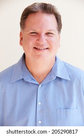 Studio Portrait Of Smiling Overweight Man