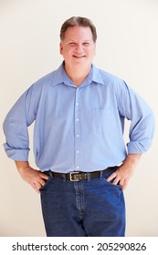 Studio Portrait Of Smiling Overweight Man