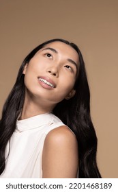 Studio Portrait Of A Taiwanese Transgender Woman In Her 20s On A Neutral Background Looking Up