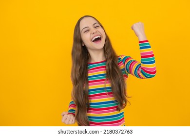 Studio Portrait Of Teenager Child Doing Winner Gesture. Kid Rejoicing, Yes Victory Champion Gesture, Fist Pump. Excited Face, Cheerful Emotions Of Teenager Girl.