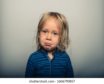 Studio Portrait Of Toddler Pulling Faces