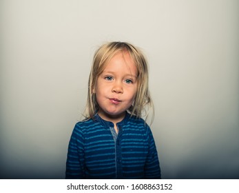 Studio Portrait Of Toddler Pulling Faces