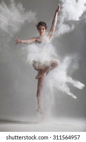 Studio portrait of woman dancing with flour