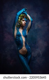 Studio portrait of woman painted on body, body paint with nature  drawing