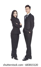 Studio Portrait Of Young Asian Business Man And Woman, Looking At Camera Smiling, Isolated On White Background.