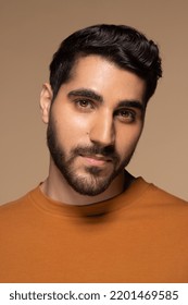studio portrait of young attractive middle eastern man in his 20s smiling on neutral background Stock Photo