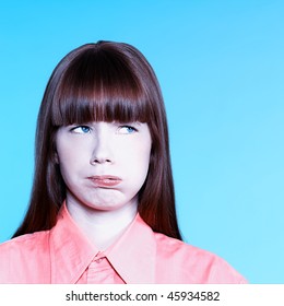 Studio Portrait Of A Young Bored Woman On Isolated Background