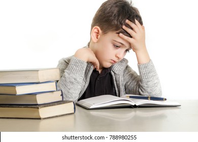 Studio portrait of young boy struggling with his homework - learning difficulties concept - Powered by Shutterstock