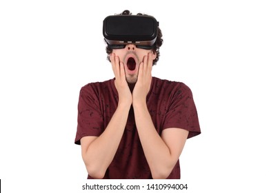 Studio portrait of young guy with VR headset is looking at interactive screen. Man experiencing virtual reality.