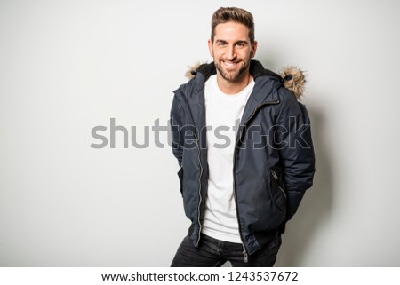 A Studio Portrait Of Young Man Wearing Winter Coat