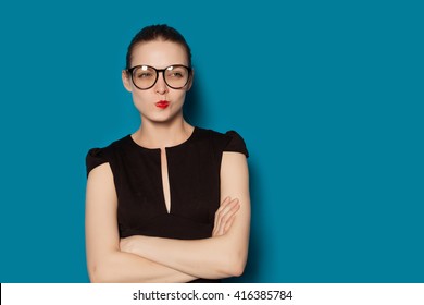Studio Portrait of young pretty thoughtful criticizing female. Colorful blue background, isolated - Shutterstock ID 416385784