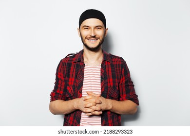 Studio Portrait Of Young Smiling Man On White Background. Wearing Red Casual Clothes And Black Head Band. Happiness Guy.