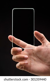 Studio Shoot Of Futuristic Transparent Phone With Man Hand On Black Background