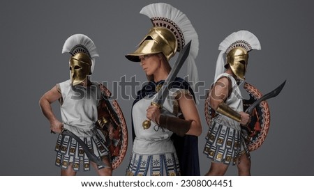 Studio shot of ancient female commander and two soldiers from greece.
