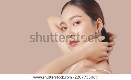 Studio shot of Beautiful young Asian woman with clean fresh skin on brown background, Face care, Facial treatment, Cosmetology, beauty and spa.