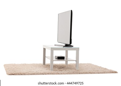 Studio Shot Of A Big Flat Screen TV White Table Isolated On White Background